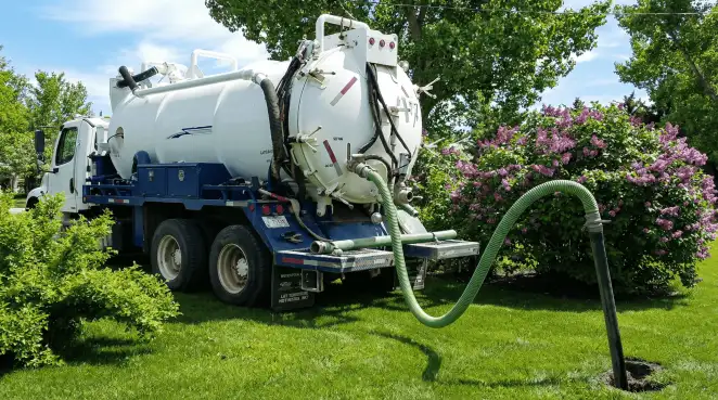 Professional vacuum truck performing residential drainage and septic maintenance in Norfolk, VA
