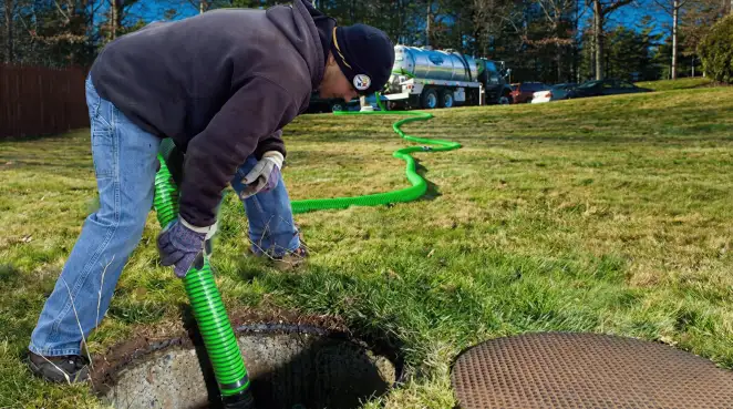 Service technician performing residential septic pumping and drainage maintenance in Norfolk, VA